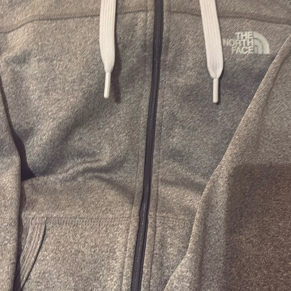 Zip up hoodie says north face size small gray hardly worn foil tag is near mint